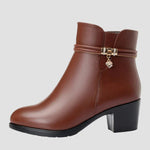 Brown ankle boots with side zipper and decorative strap with heart charm
