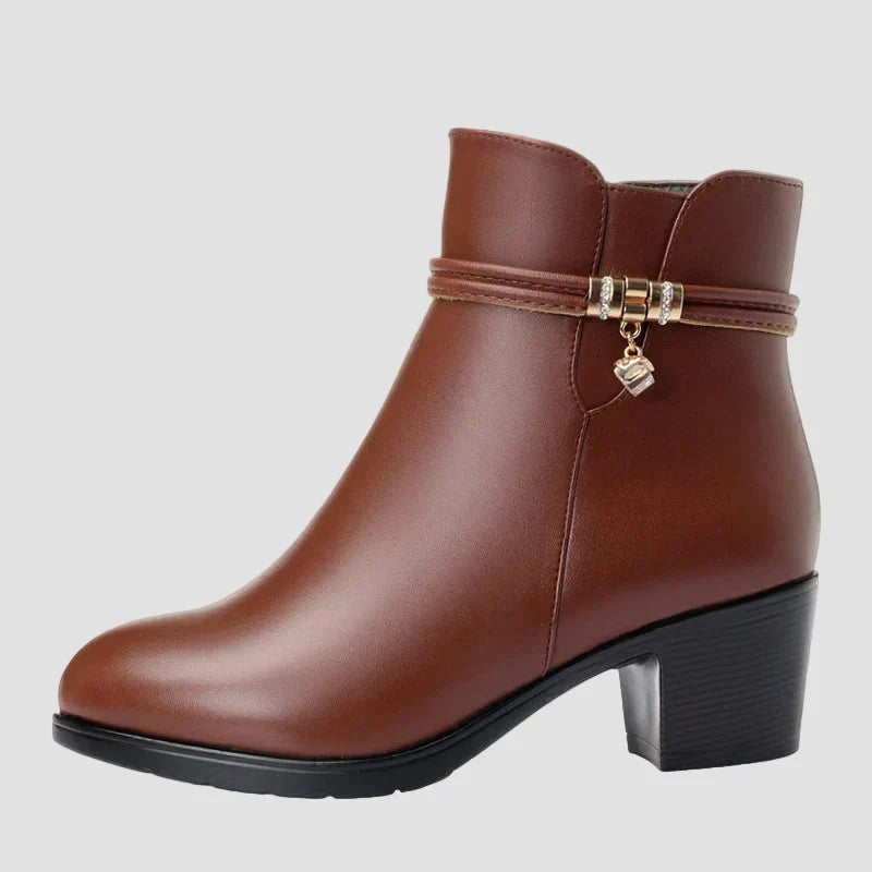 Brown ankle boots with side zipper and decorative strap with heart charm