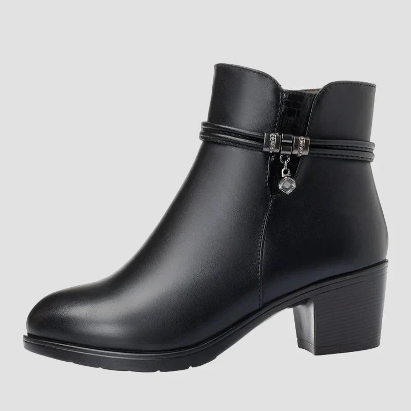 Black ankle boots with side zipper and decorative strap with heart charm