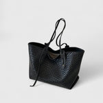 Black woven tote bag with two top handles and zip closure
