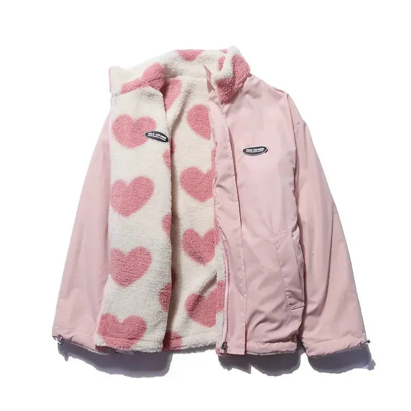 Light pink reversible winter jacket showing heart-fleece lining with stand collar