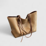 Light gold woven tote bag with two top handles and zip closure