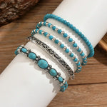 Turquoise beaded bracelet set with silver filigree bars and oval turquoise charms