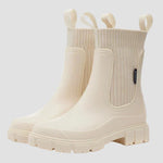 Waterproof white Chelsea boots with elastic side panels and chunky tread sole