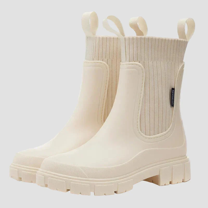 Waterproof white Chelsea boots with elastic side panels and chunky tread sole