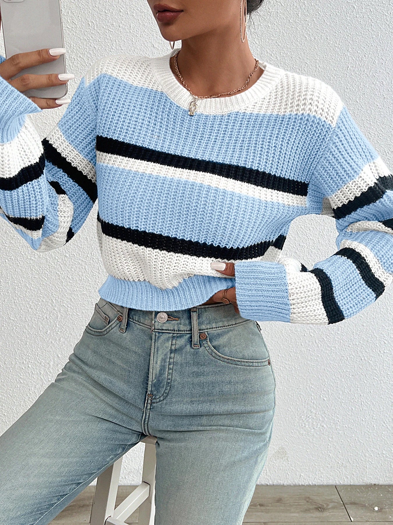 Oversized knit sweater in light blue and off-white with black horizontal stripe