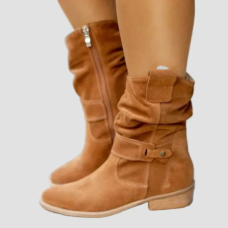 Light brown suede ankle boots with side buckle straps and low stacked heel