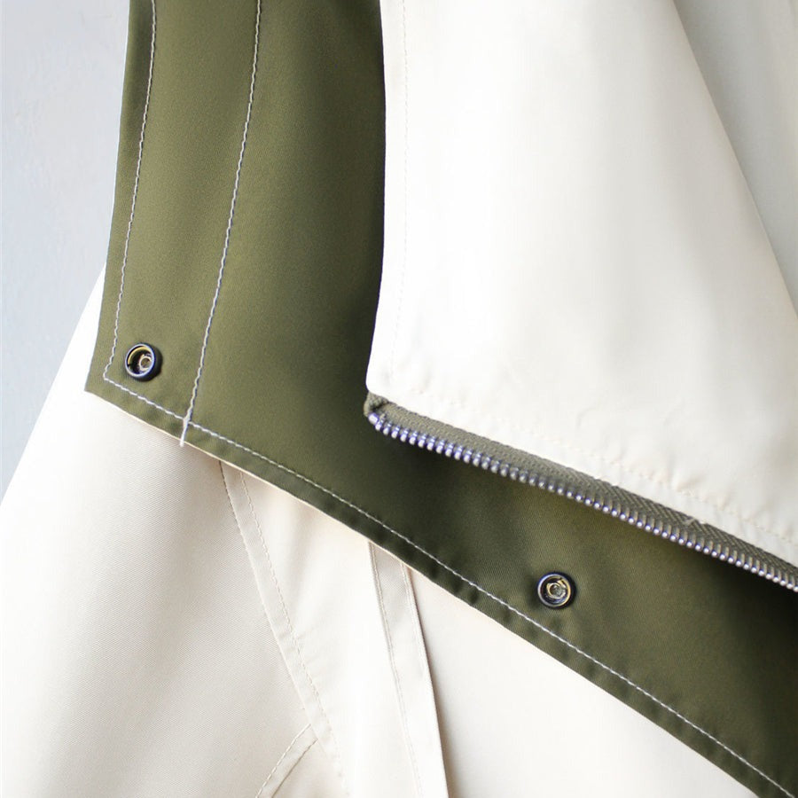 Hem and button detail on two-tone parka jacket, olive panel with cream trim