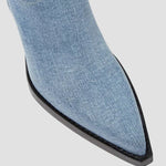 Close-up of light blue knee-high boot toe with black sole edge