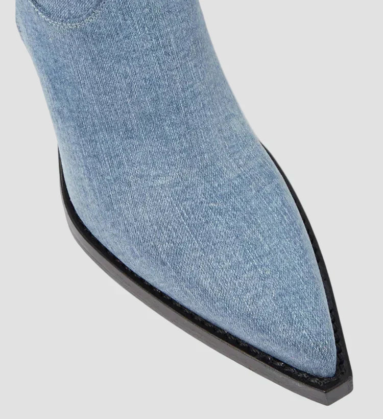 Close-up of light blue knee-high boot toe with black sole edge