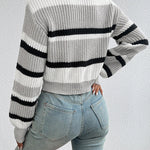 Back view of oversized knit sweater in off-white with two black horizontal stripes