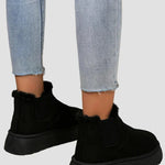 Black ankle boots with elastic side panels and rounded thick rubber sole