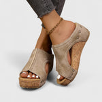 Beige platform orthopedic wedge sandals with cutout straps and stud detail