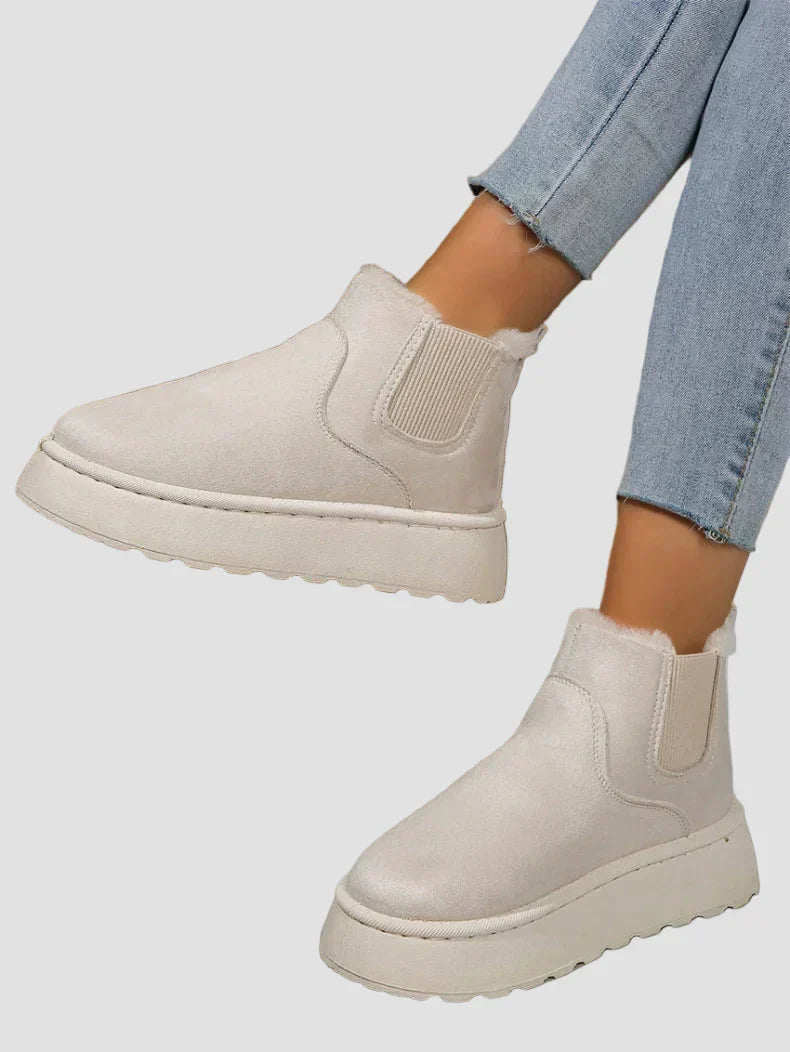 Beige winter ankle boots with elastic side panels and thick rubber sole