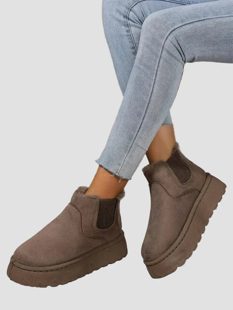 Dark brown winter ankle boots with elastic side panels and thick rubber sole