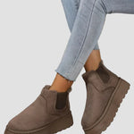 Dark brown winter ankle boots with elastic side panels and thick rubber sole