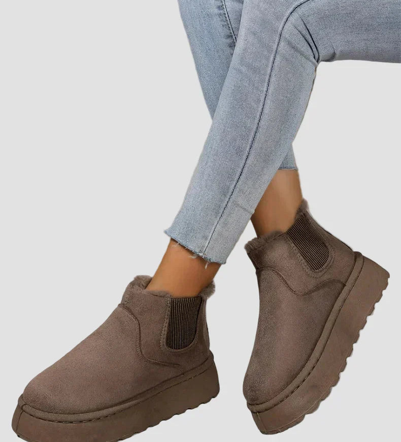 Dark brown winter ankle boots with elastic side panels and thick rubber sole