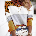 Leopard print knit pullover sweater with white and gray center and orange spotted sleeves