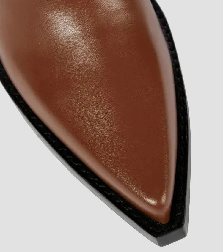 Brown boot toe with leather-look texture and black-edged sole