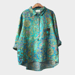 Teal button-up blouse with gold floral medallion pattern and chest pockets