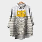 Patterned button-up blouse with pointed collar, yellow graphic detail, and striped sleeves