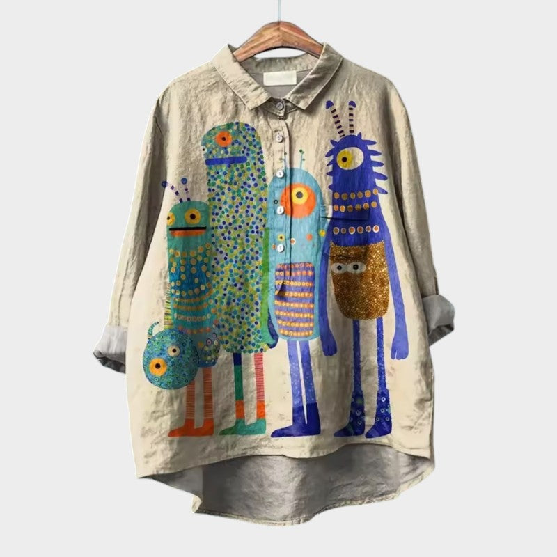 Light beige long-sleeve button-up blouse with colorful character print and collared neckline