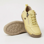 Yellow sport orthopedic sneaker with lace-up, side zipper, and grippy beige outsole.