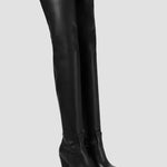 Black over-the-knee heeled boots with pointed toe and sleek leather-look finish