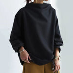 Black high-neck pullover sweater with long sleeves and loose silhouette