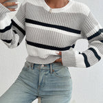 Oversized knit sweater in off-white with black horizontal stripe across chest and sleeves