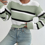 Oversized knit sweater in green and off-white with black horizontal stripe and ribbed hem