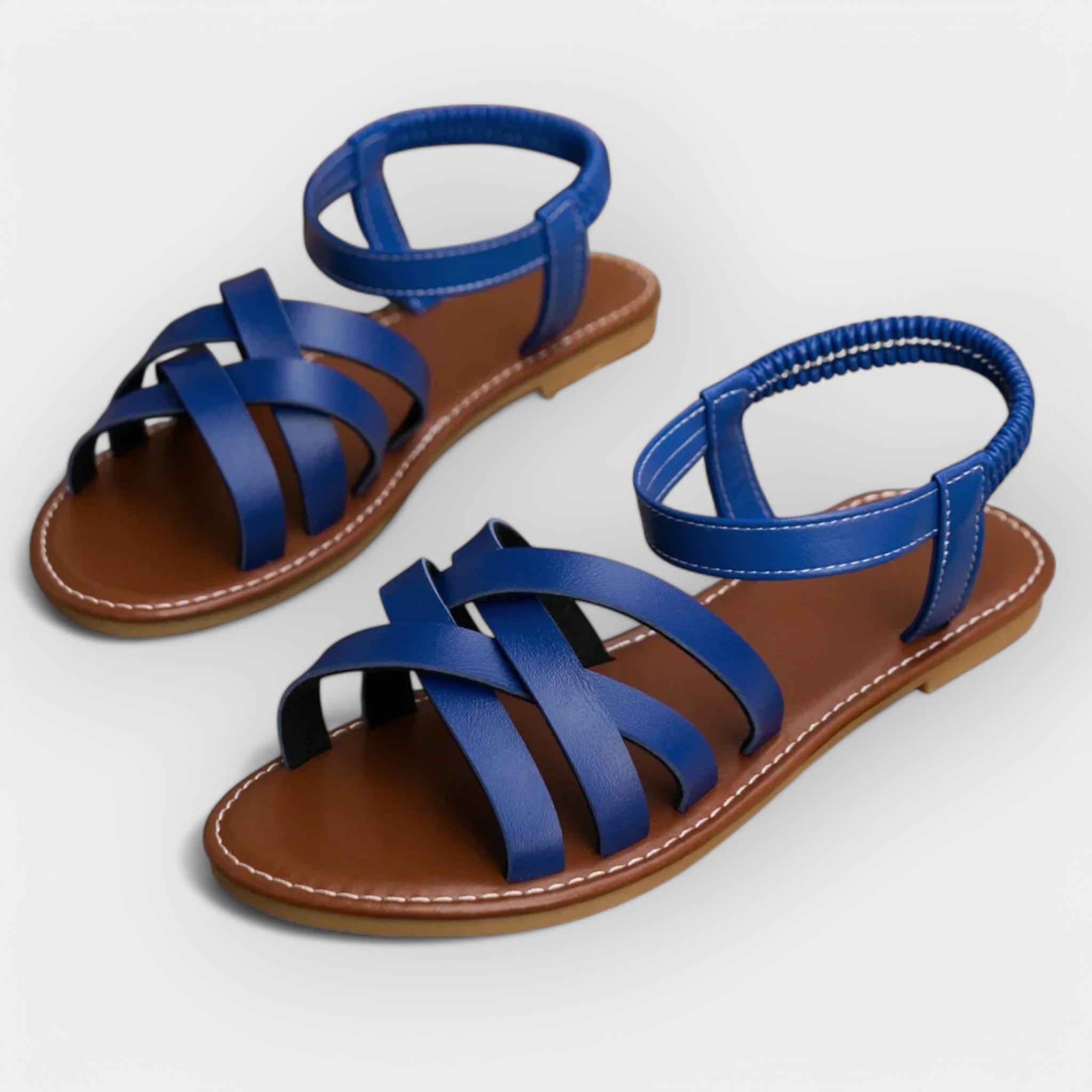 Handmade blue flat sandals with wide toe straps and ankle strap