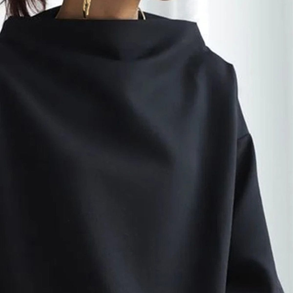 Black high-neck pullover sweater close-up of neckline and shoulder