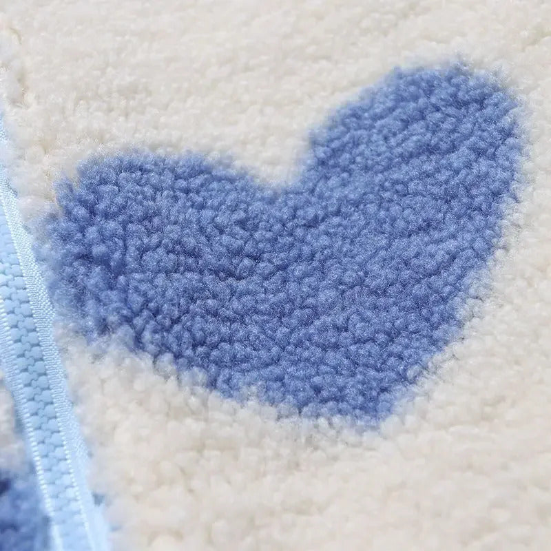 Close-up of cream fleece fabric with large blue heart pattern