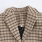 Plaid coat neckline detail with notched collar and buttoned placket
