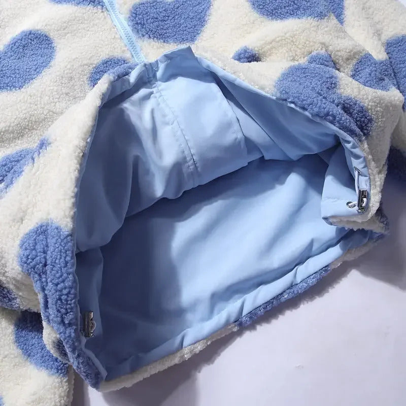 Open reversible jacket showing light blue inner lining and heart fleece