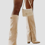 Cream tall boots with block heel and buckle detail at the cuff