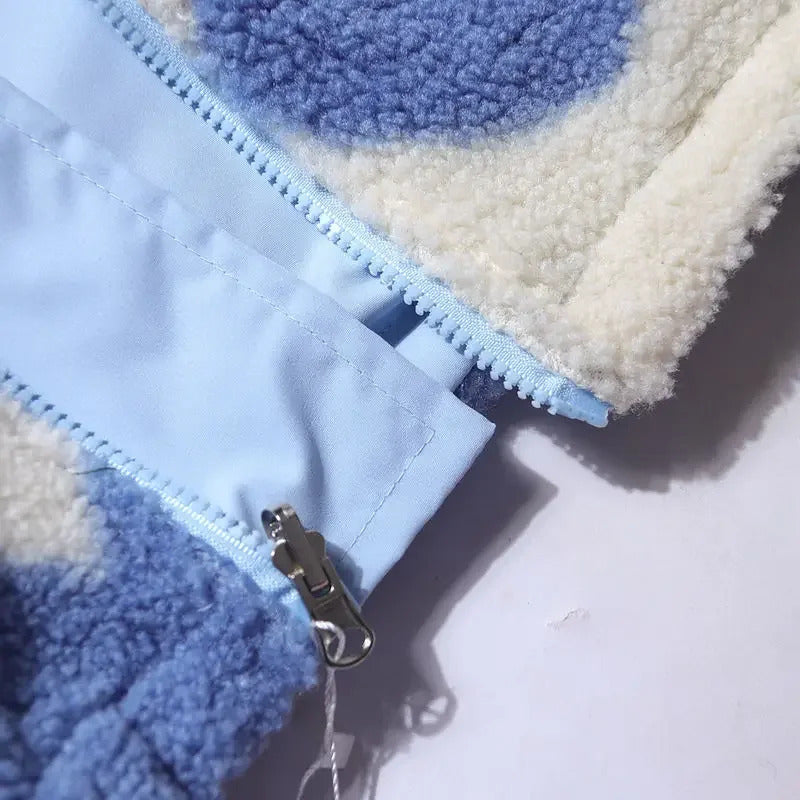 Close-up of reversible jacket zipper and light blue front panel