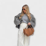 Brown leather-look hobo tote bag with curved top handles and structured sides