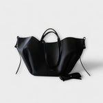 Black leather-look hobo tote bag with curved handles and side tie straps