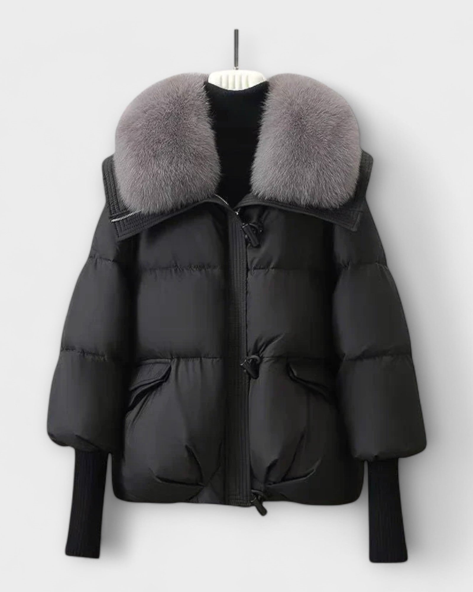 Black puffer jacket with faux fur collar, zip front, flap pockets.