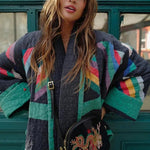 Quilted jacket on model: dark base with teal, pink, and striped geometric panels, zip front