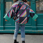 Quilted jacket back view with large multicolor geometric blocks and ribbed cuffs
