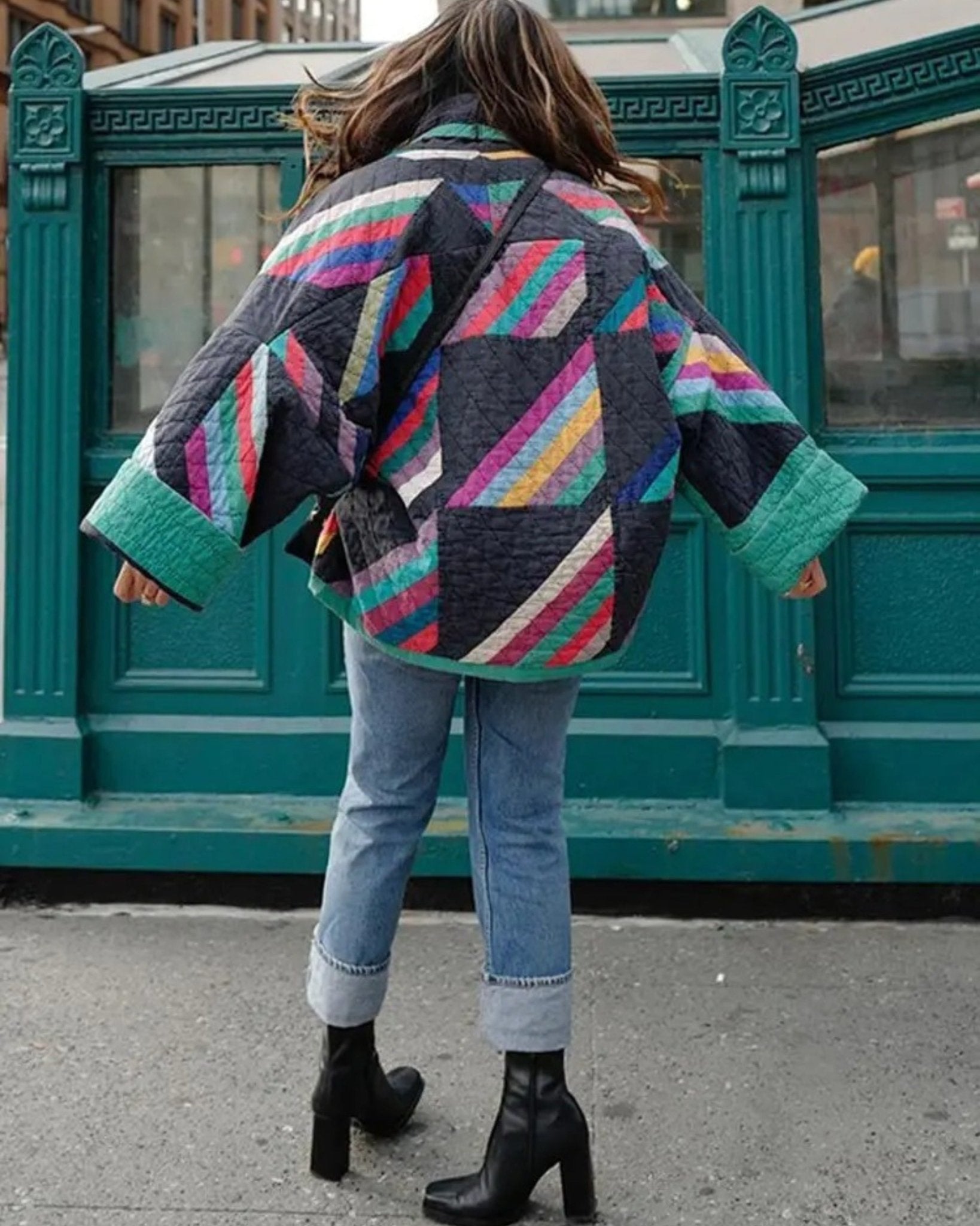 Quilted jacket back view with large multicolor geometric blocks and ribbed cuffs