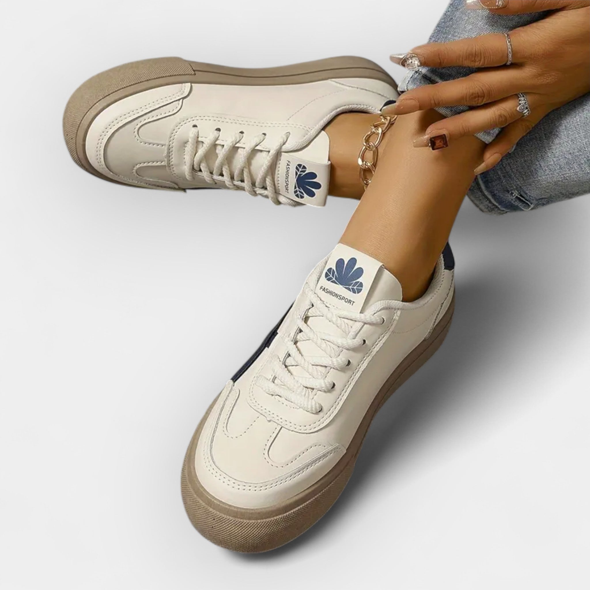 White platform retro sneakers with navy stripe accents and tan outsole, lace-up style.
