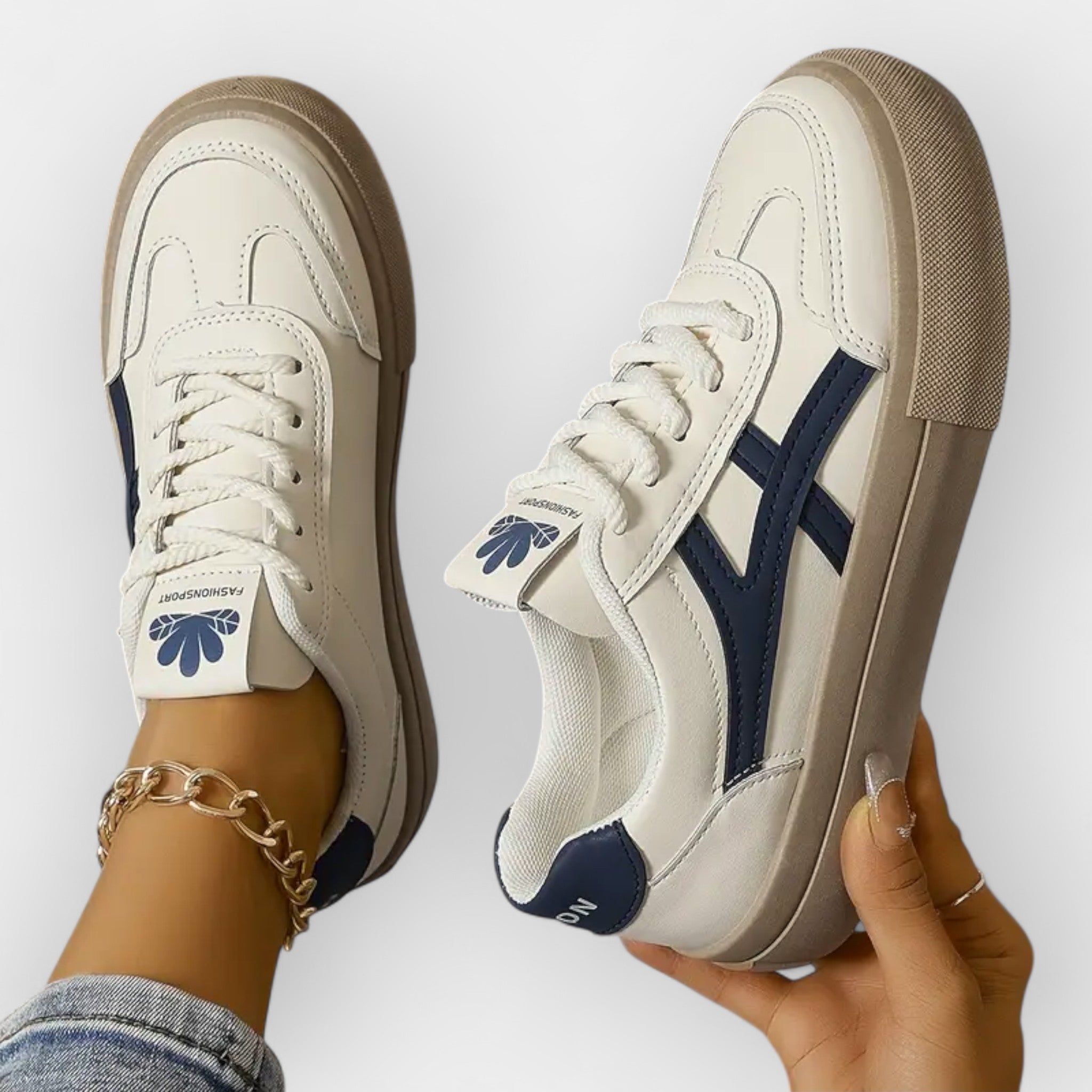 Platform retro sneakers, white leather with navy stripes and tan rubber sole, lace-up.