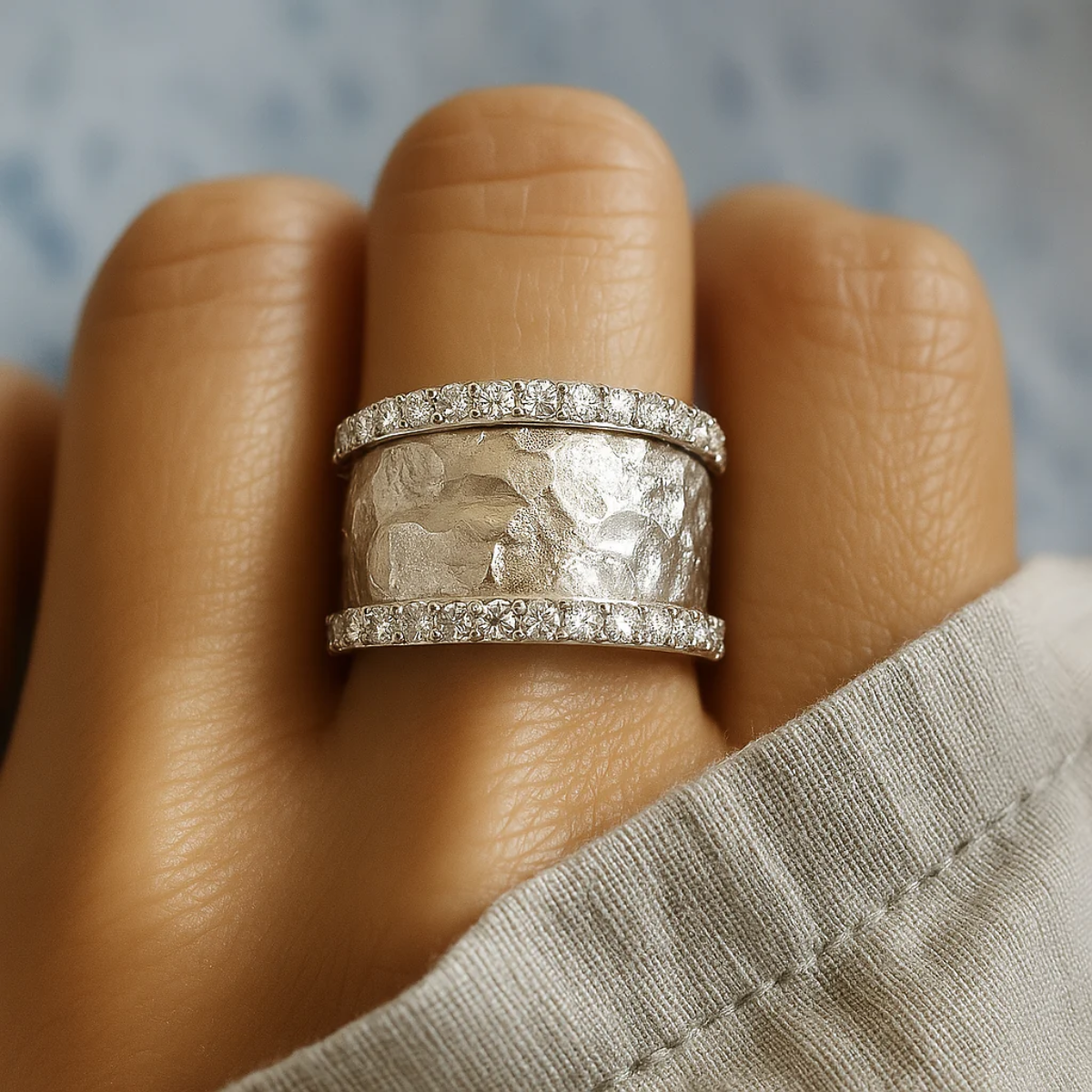 Vintage silver ring with faceted zirconia stones on a wide textured band