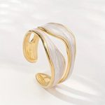 Open wavy gold-tone ring with curved band and glossy finish