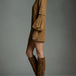 Brown oversized mini sweatshirt dress in profile, high neck and sleeve pocket