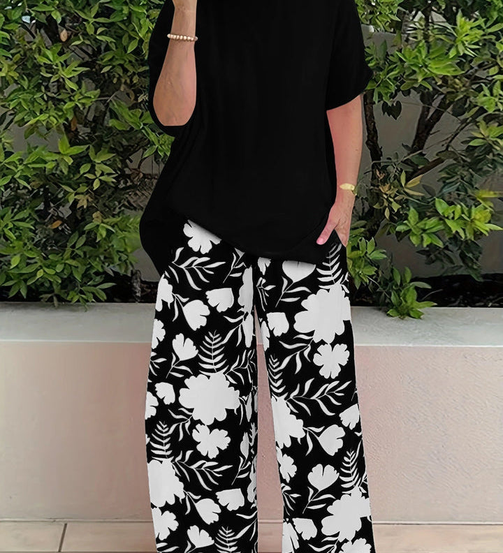 Isolde two-piece set: black blouse with short sleeves and black floral wide-leg pants